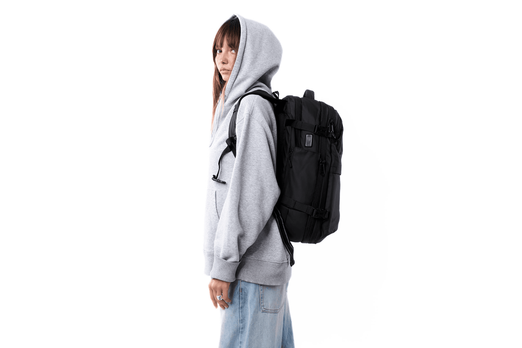 Side view of person wearing MOVO BAGS carry-on travel backpack