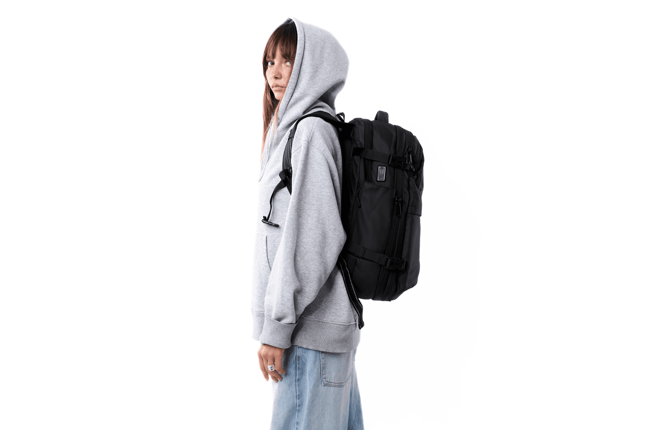 Side view of person wearing MOVO BAGS carry-on travel backpack